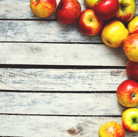 Some red and yellow apples on the white wooden table. food and dietary concept. picture with free space for textの写真素材