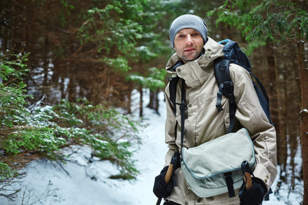 hiker with backpack on the trail in the Carpathians mountains at winter