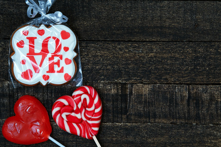 festive Gingerbread with Love word and red sweet hearts on wooden table. Valentines Day conceptの写真素材