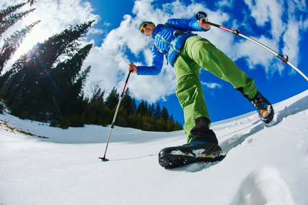 hiker with backpack on the trail in the Carpathians mountains at winter. picture of hiker taken on wide angle from low pointの写真素材