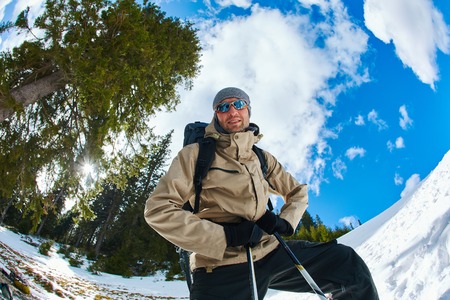 hiker with backpack on the trail in the Carpathians mountains at winter. picture of hiker taken on wide angle from low pointの写真素材