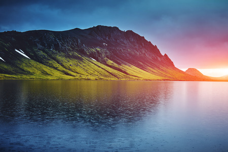Lake coast with mountain reflection at the sunrise, Iceland. treking in Iceland. Travel concept.の写真素材