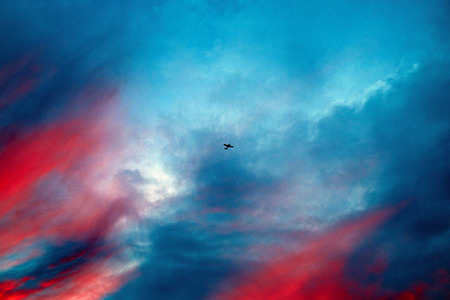 Texture of bright evening sky during sunset. Small plane in the skyの写真素材