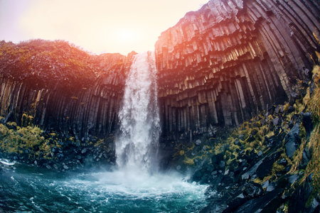 Svartifoss Black Fall , Skaftafell, Iceland. Dramatic waterfall surrounded by dark basalt lava...