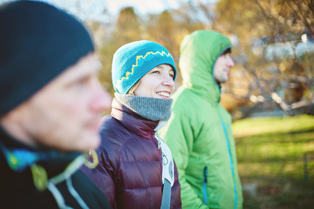 three friends walk in the winter on a sunny cold dayの写真素材