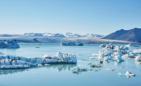 Beatufil vibrant picture of icelandic glacier and glacier lagoon with water and ice in cold blue...