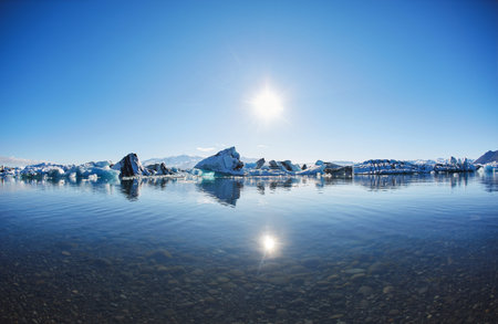 Beatufil vibrant picture of icelandic glacier and glacier lagoon with water and ice in cold blue...