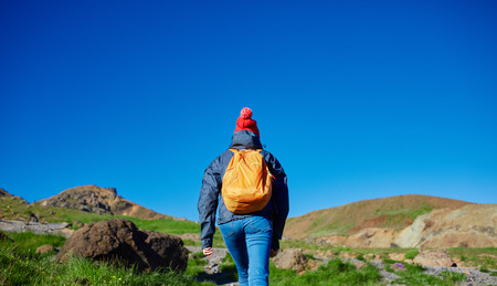 back view of woman traveler on a walk in the Valley of the river of Hveragerdi Iceland. Hiking Tour of Reykjadalur Hot Springsの写真素材