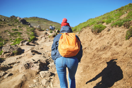back view of woman traveler on a walk in the Valley of the river of Hveragerdi Iceland. Hiking Tour of Reykjadalur Hot Springsの写真素材