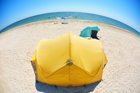 orange tent on the beach at bright sunny day. Travel photography conceptの写真素材