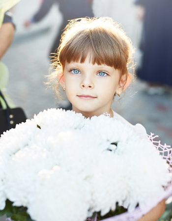 portrait of a little girl with a big bouquet of flowers.の写真素材