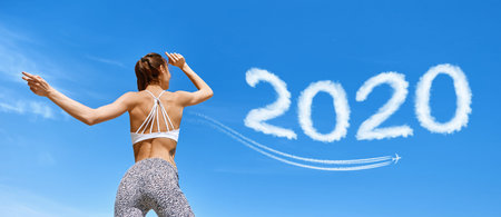 attractive tanned fitness woman with muscular back and tight buttocks posing at hot summer day...