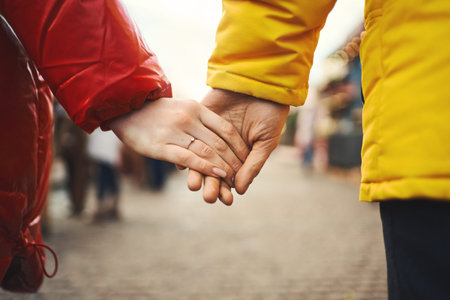 winter couple holding hands while walking city street. Romantic young couple enjoying walk and travel. Couple on winter vacation travel holiday.の写真素材
