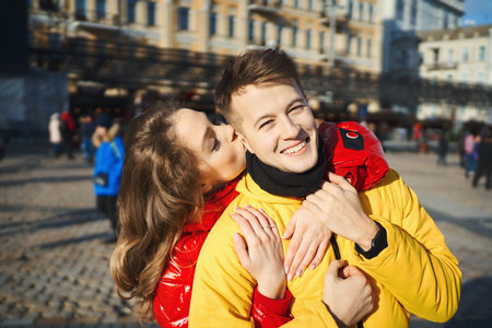 outdoor portrait of young happy couple in love spending time together in the city at sunny day....