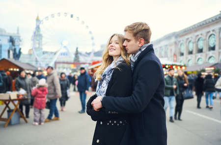 elegant romantic couple in love hugging and kissing on street with attraction on background. Spending time together in the city, having a date. urban romantic portrait. Romantic, love and Valentine's Day concept.の写真素材