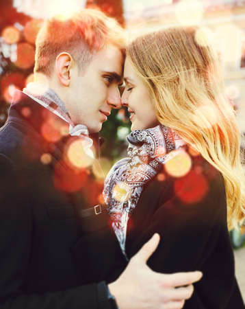 portrait of young loving couple embracing with eyes closed, close to each other. happy moments together. having a date. Concept of first kiss, tenderness and love. tinted image with bokehの写真素材