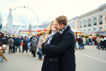 portrait of elegant couple in love hugging and kissing on street with attraction on background. Spending time together in the city, having a date. urban romantic portrait. Romantic, love and Valentine's Day concept.の写真素材