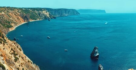Wide angle view of beautiful landscape with bay of water with high limestone cliff over blue sea and clear deep blue sky. beautiful scenery of natural environment, seascape at summer sunriseの写真素材