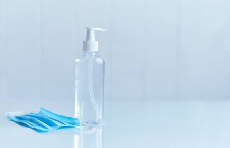 Coronavirus prevention, bottle of hand sanitizer for hand hygiene corona virus protection and medical protective masks on white background. COVID-19 Coronavirus conceptの写真素材