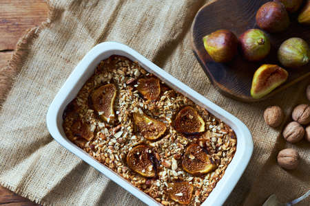 Autumn baking, sweet homemade pie with figs and nuts. Food flat lay on craft kitchen background. Kitchen or bakery poster design.の写真素材