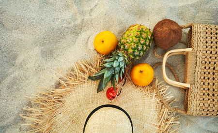 Top view summer female fashion outfit and tropical fruit flat lay on sandの写真素材