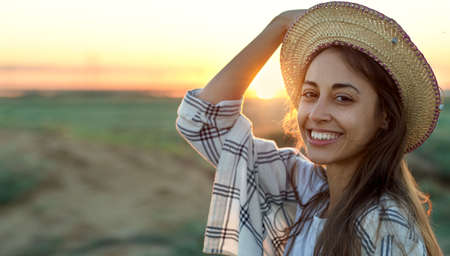 Close up portrait of charming american woman smiling at sunset, felling good and caerfreeの写真素材