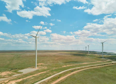 Panoramic View of Wind Turbine Farm on agricultural field with blue cloudy sky in Ukraine.の写真素材