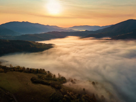 Beautiful mystery landscape with sunset sky and foggy forest between mountains hills. Carpathians mountains in Ukraineの写真素材