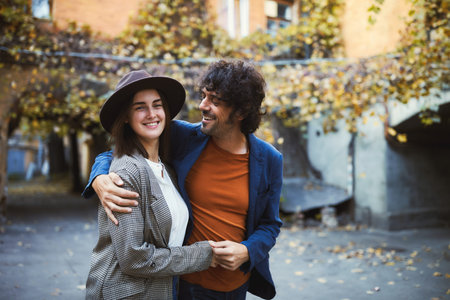 Loving young couple hugging and smiling together during walking in city