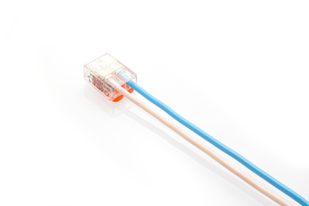 Compact splicing connector with connected wire isolated on white background.の写真素材