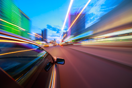 The car moves at fast speed at the night. Blured road with lights with car on high speed.の写真素材