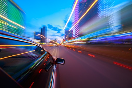 The car moves at fast speed at the night. Blured road with lights with car on high speed.の写真素材