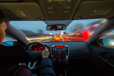 Night road view from inside car natural light street and other cars is motion blurredの写真素材