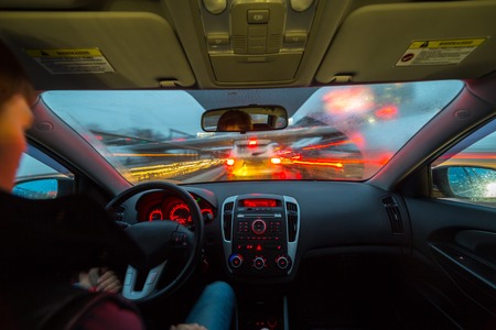 Night road view from inside car natural light street and other cars is motion blurredの写真素材