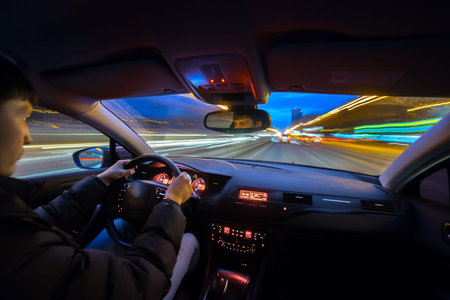 City road view from inside car natural light street and other cars is motion blurred