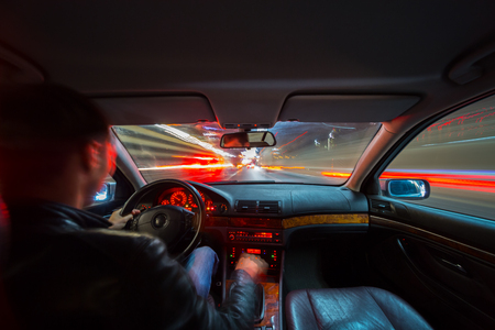 City road view from inside car natural light street and other cars is motion blurredの写真素材