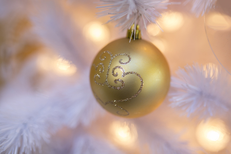 details of Christmas balls and decorations on a white christmas treeの写真素材