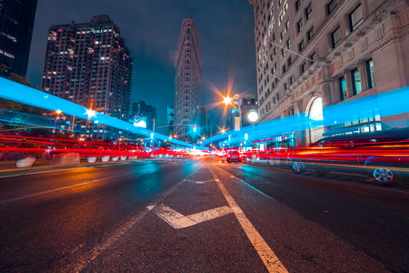 Taxi light trails on cross road in New York City at nightの写真素材