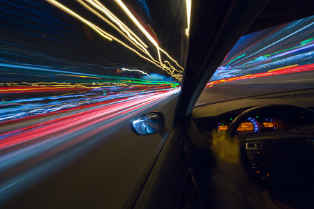 The car moves at high speed at the night. View from driver side.の写真素材