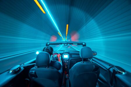 Abstract speed concept. Driver in a cabrio vehile ina a tunnel. motion blur.の写真素材