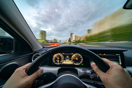 Movement of the car at night at high speed view from the interior with driver hands on wheel....