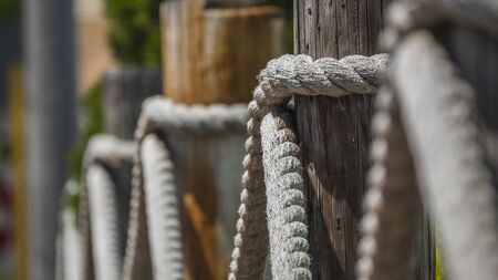 Log and rope fence, shallow depth of field imageの写真素材