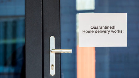 Quarantine announcement on the door of the store and the possibility of ordering with home deliveryの写真素材