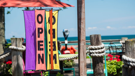 The sign is open on the summer playground of a cozy cafe near the lake