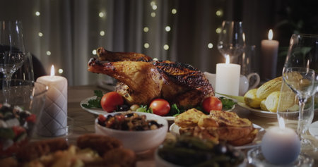 Roasted turkey on the festive table - a traditional dish for Christmas and Thanksgivingの写真素材