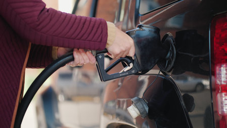 A woman is running her black car.の写真素材