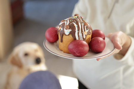A festive Easter plate with a decorated cake topped with chocolate icing and sprinkles, surrounded...