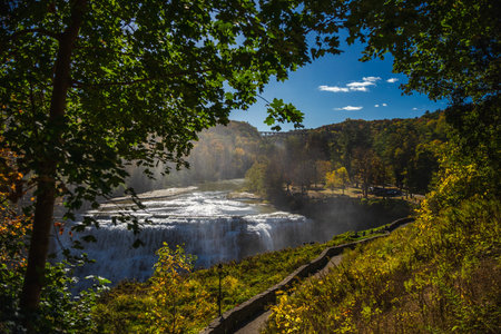 Autumn landscape with the Middle Falls waterfall at Letchworth State Park in New York framed by...