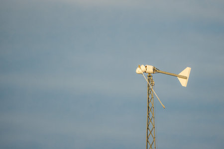 Broken wind turbine after storm damage against blue sky in the United Statesの写真素材