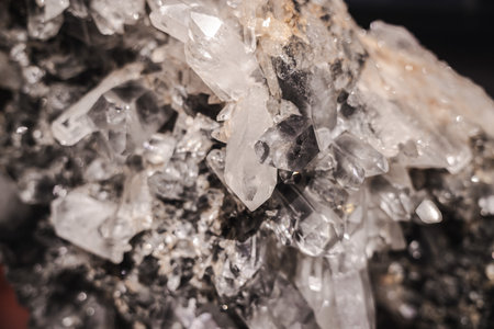 Natural quartz formation with sharp translucent crystals and detailed geometric facets in warm lightの写真素材